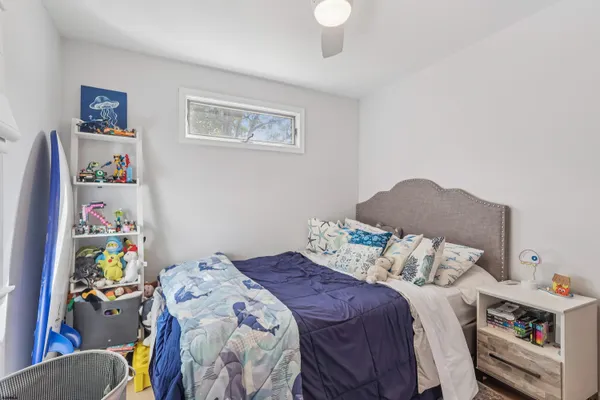 a bedroom with a bed and a window