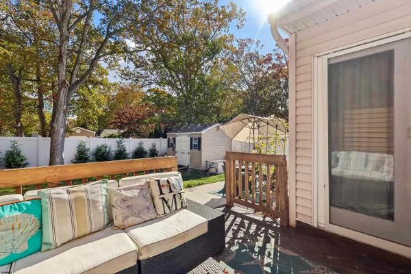 a balcony with furniture and wooden floor