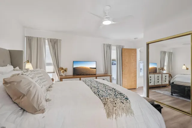 a bedroom with a bed and a flat tv screen