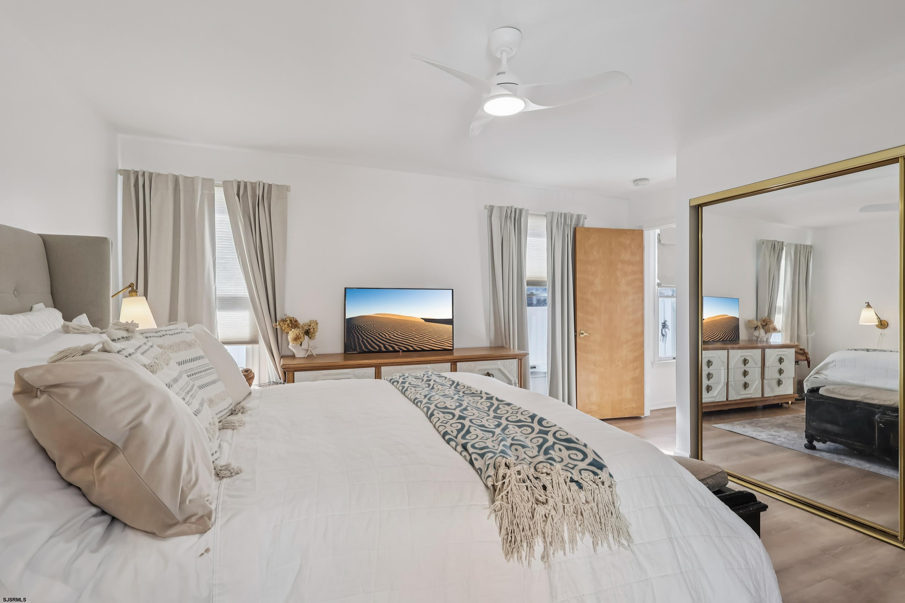 746 4th Street Somers Point, NJ 08244 - Photo 28 of 39 a bedroom with a bed and a flat tv screen