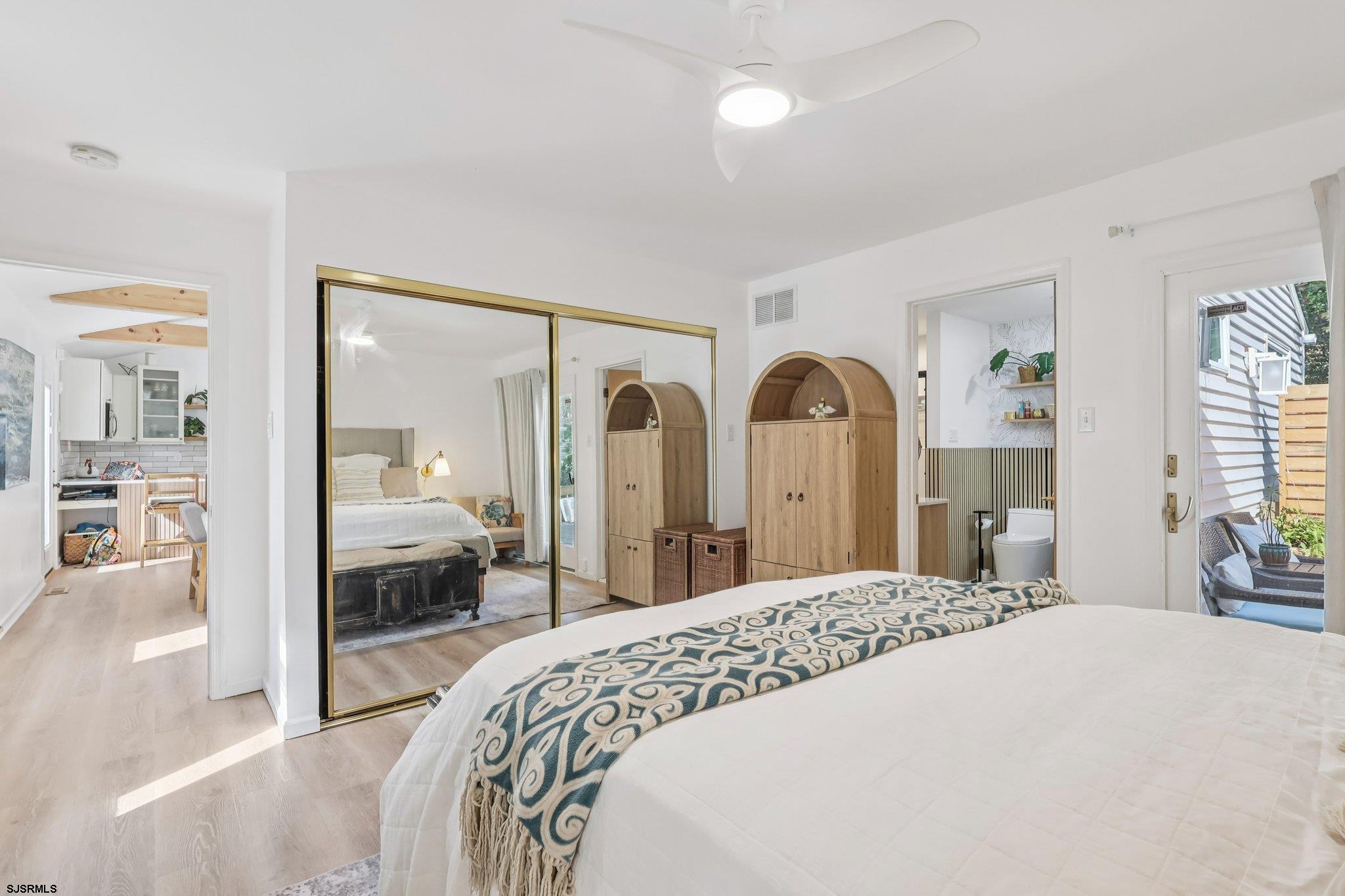 746 4th Street Somers Point, NJ 08244 - Photo 30 of 39 a bedroom with a large bed and a large mirror