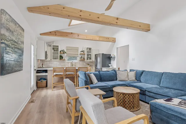 a living room with furniture and a dining table