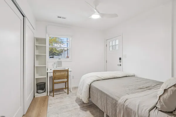 a bedroom with a bed and a window