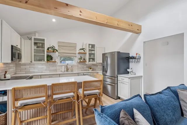 a kitchen with stainless steel appliances a refrigerator and cabinets