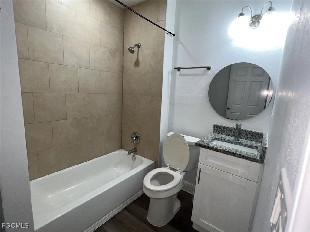 4180 Sabal Lane, Unit 2 Fort Myers, FL 33905 - Photo 4 of 11 a bathroom with a toilet a sink and bathtub