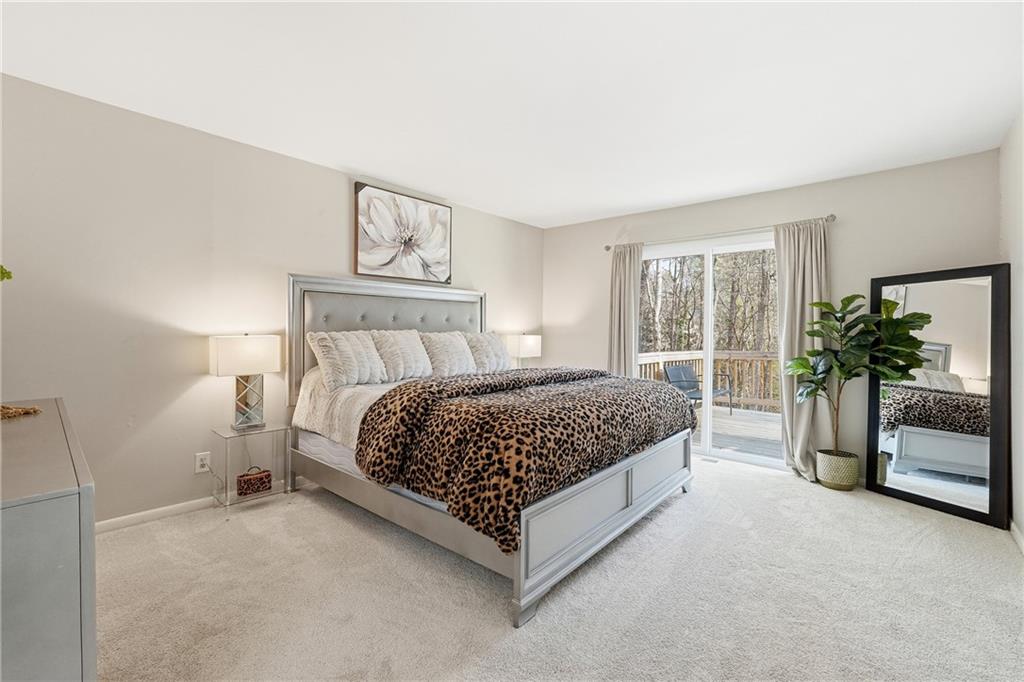 1720 Little Willeo Road Marietta, GA 30068 - Photo 11 of 26 a bedroom with a large bed and a potted plant