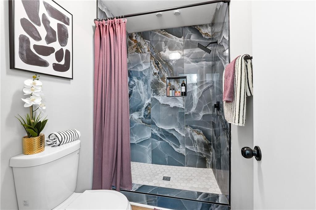 1720 Little Willeo Road Marietta, GA 30068 - Photo 14 of 26 a bathroom with a shower and toilet