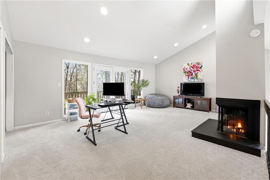 1720 Little Willeo Road Marietta, GA 30068 - Photo 15 of 26 a living room with furniture a flat screen tv and a fireplace