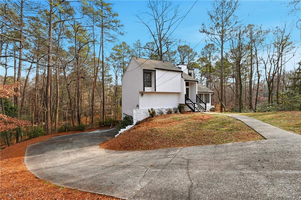 1720 Little Willeo Road Marietta, GA 30068 - Photo 25 of 26 a house with trees in front of it