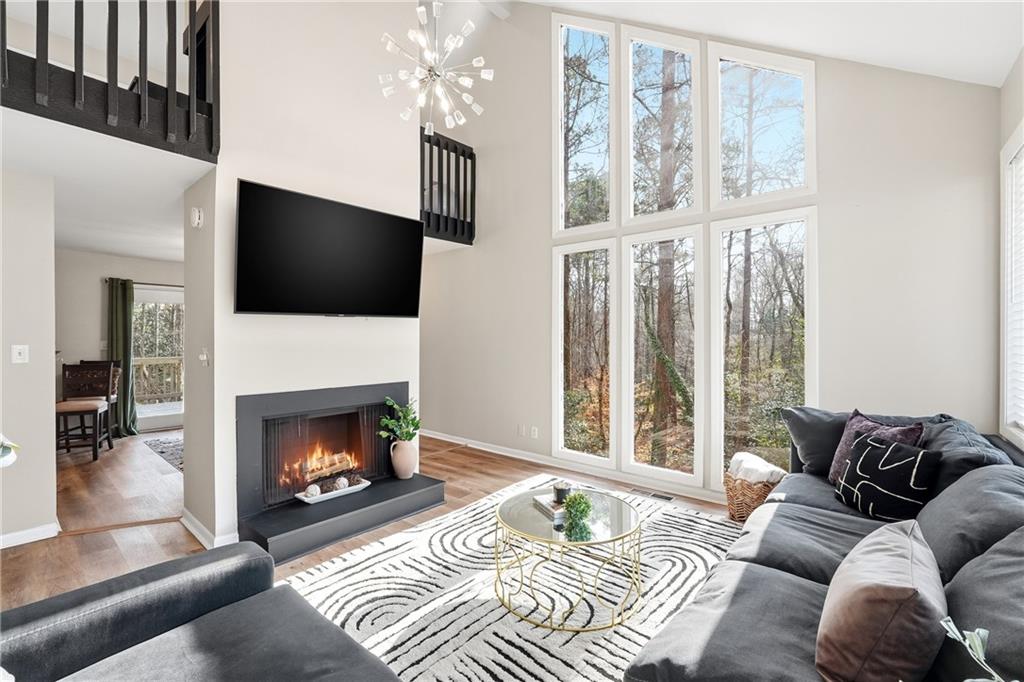 1720 Little Willeo Road Marietta, GA 30068 - Photo 5 of 26 a living room with furniture a flat screen tv and a fireplace