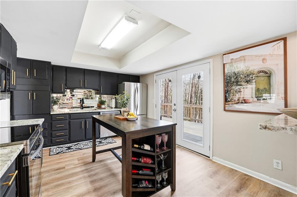 1720 Little Willeo Road Marietta, GA 30068 - Photo 7 of 26 a kitchen with stainless steel appliances wooden floor and a refrigerator