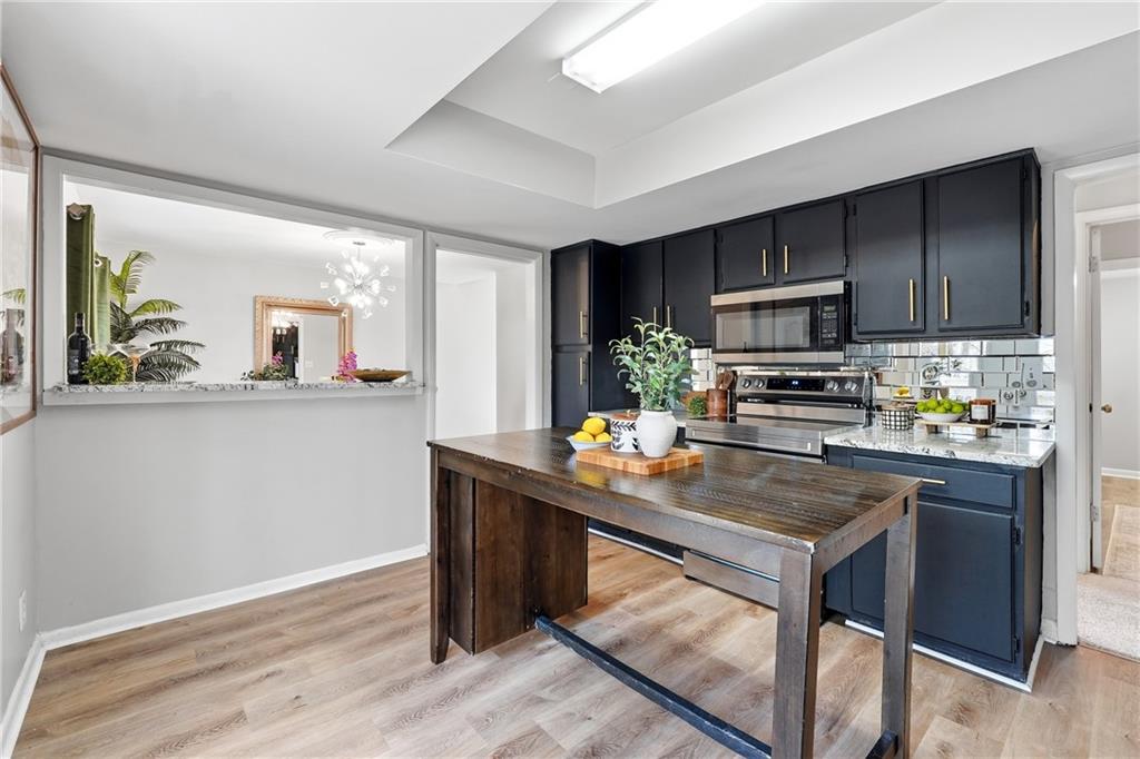 1720 Little Willeo Road Marietta, GA 30068 - Photo 9 of 26 a kitchen with kitchen island a counter space and a sink