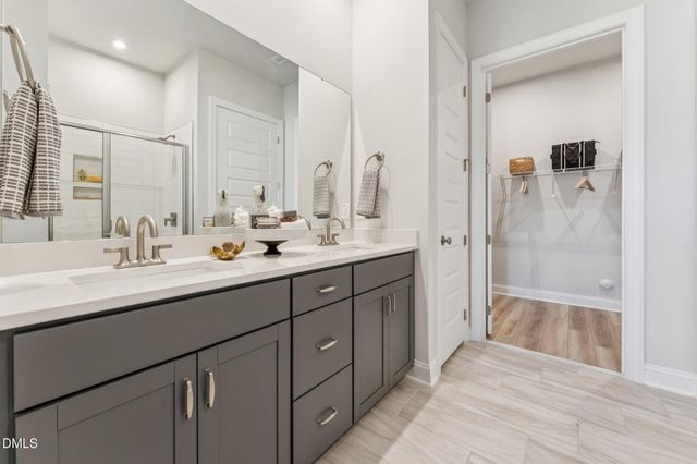 a bathroom with a sink toilet a mirror and shower