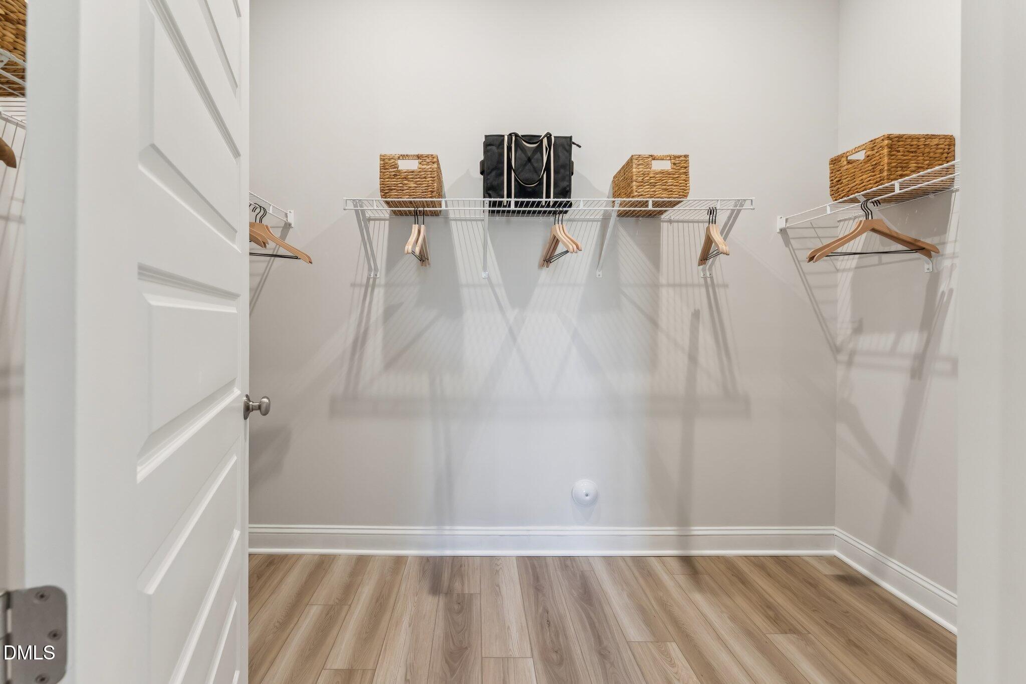 2120 Barrier Ridge Way Apex, NC 27502 - Photo 19 of 43 a view of walk in closet with clothes and shoes