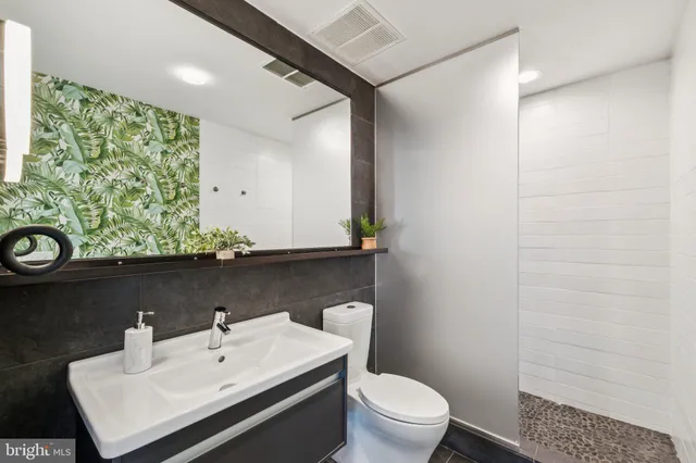 a bathroom with a sink toilet and mirror