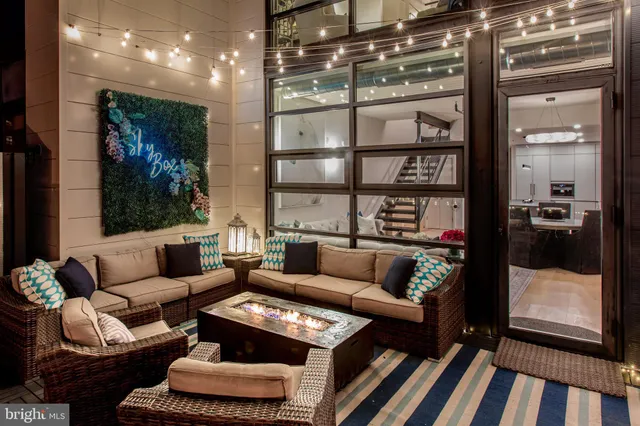 a living room with furniture and a floor to ceiling window