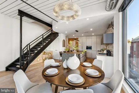 a dining room with furniture and wooden floor