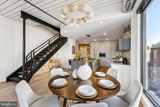 a dining room with furniture and wooden floor