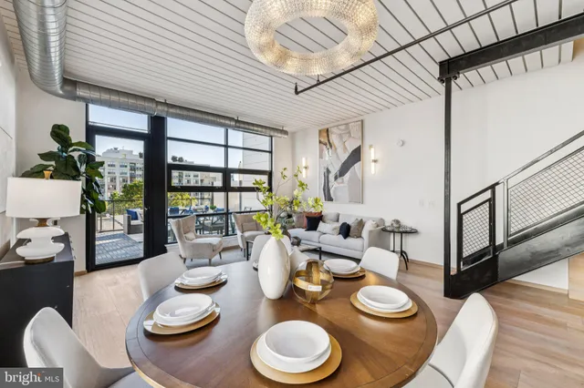 a dining room with furniture a rug and wooden floor