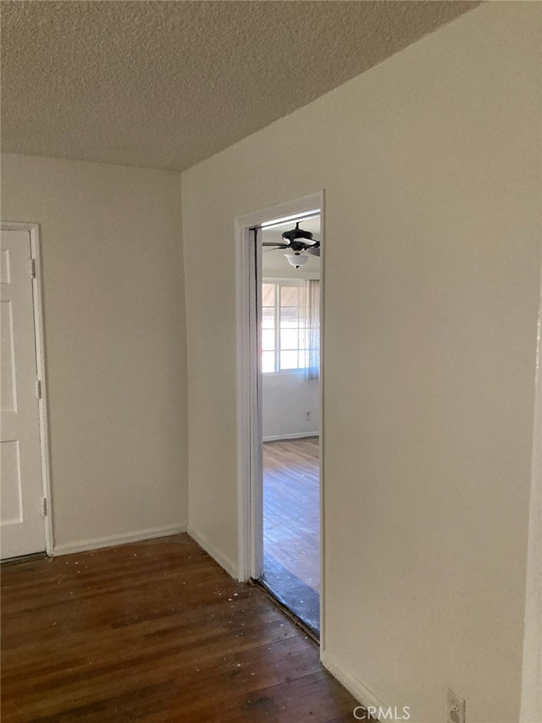 1306 South Cliveden Avenue Compton, CA 90220 - Photo 12 of 19 a view of empty room with wooden floor and window