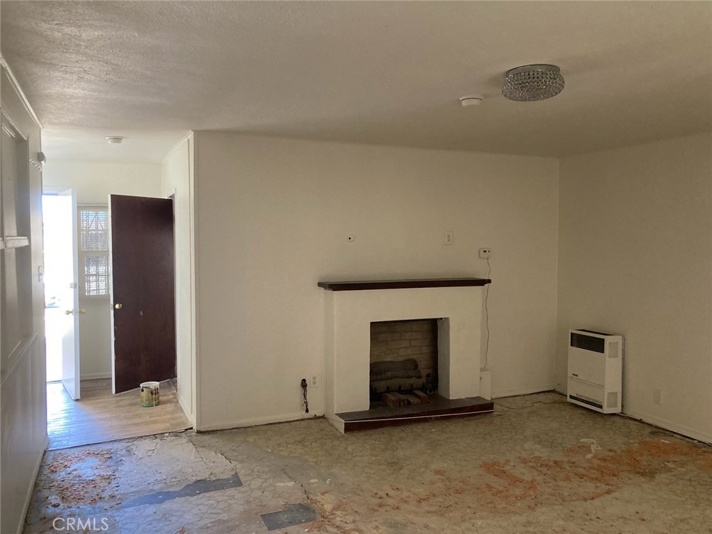 1306 South Cliveden Avenue Compton, CA 90220 - Photo 19 of 19 an empty room with a fireplace