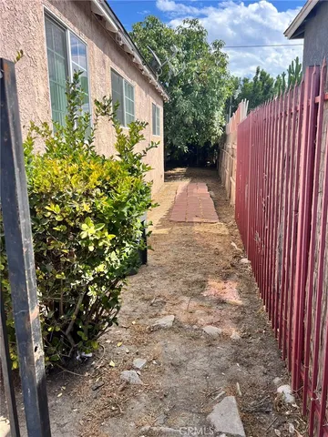 a view of a pathway with a garden