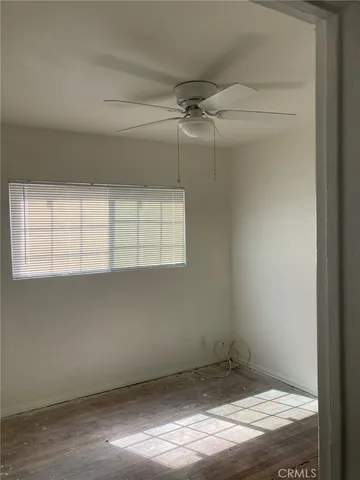 a view of a room with rack on the wall and a window
