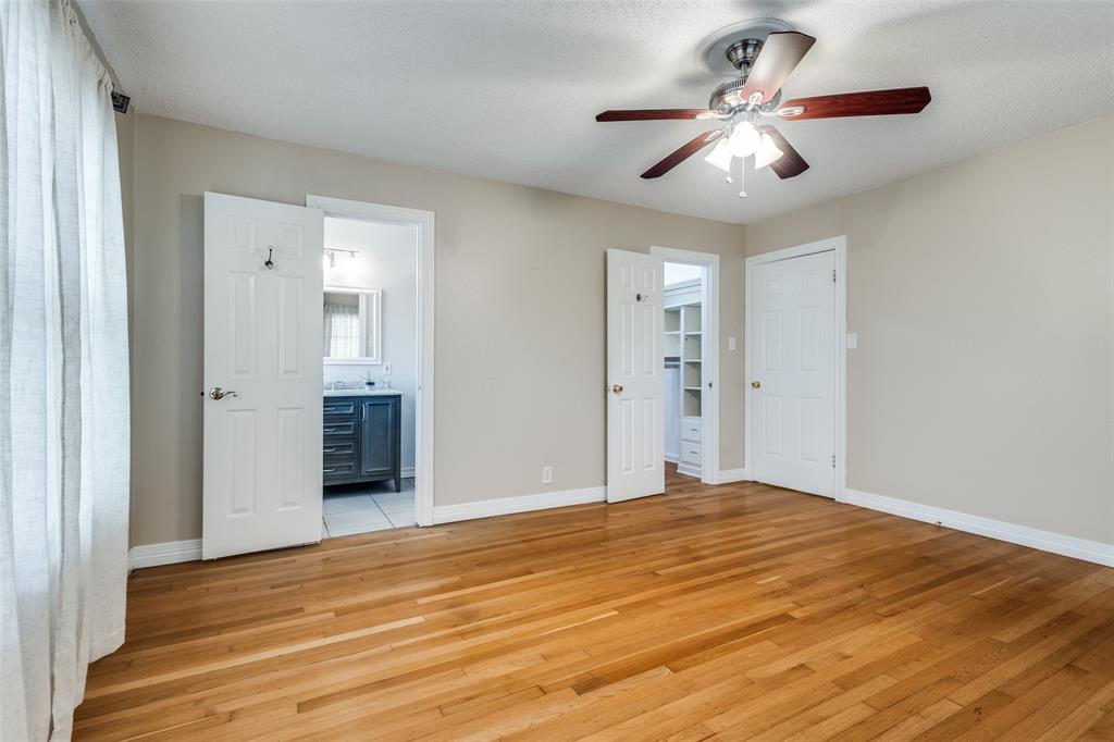 433 Fulton Street Denton, TX 76201 - Photo 15 of 25 a view of a big room with wooden floor and a ceiling fan