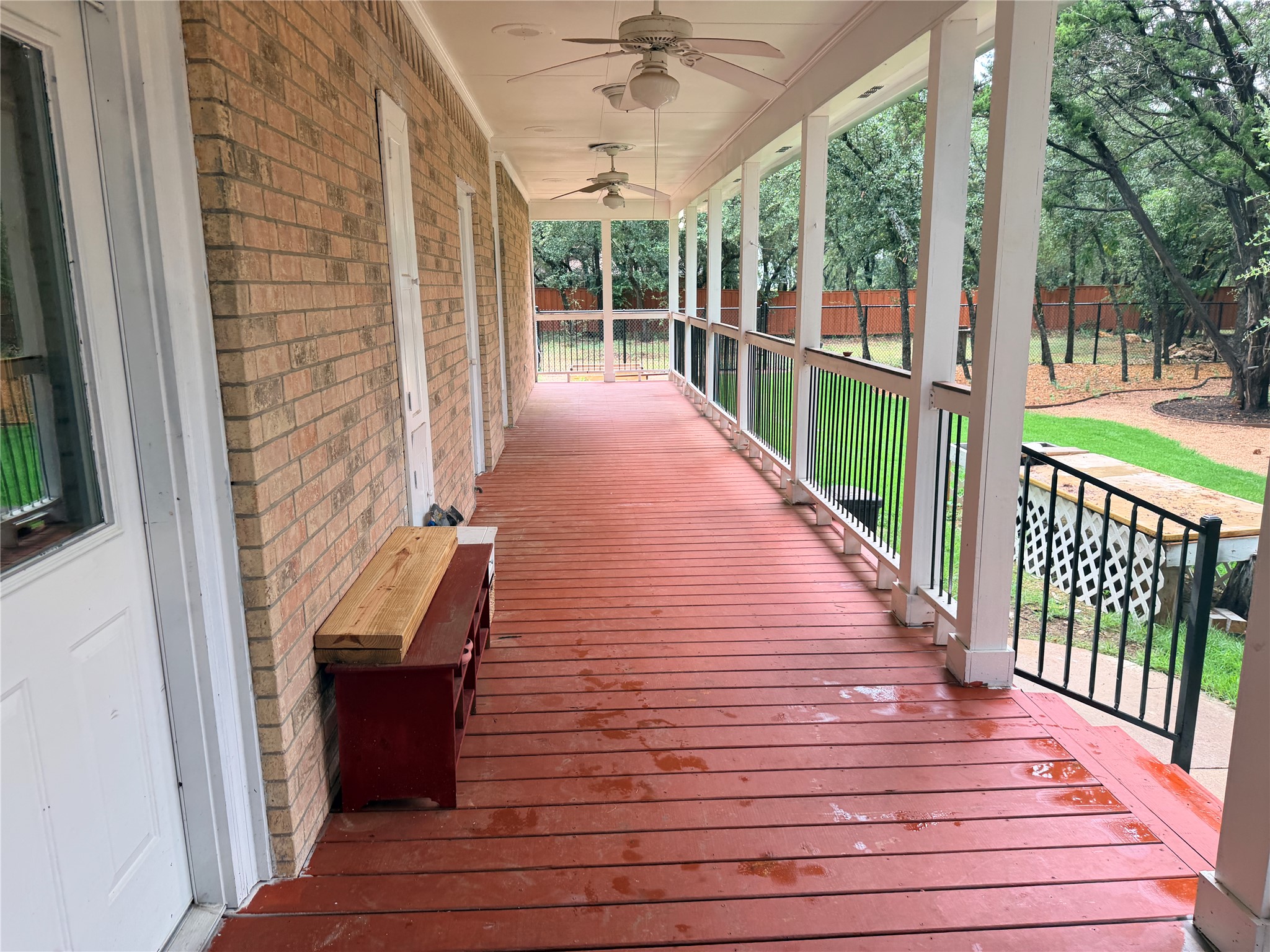 7130 Ranch 2338 Road Georgetown, TX 78633 - Photo 13 of 35 An expansive covered back porch features classic brick walls and overlooks the wooded yard.