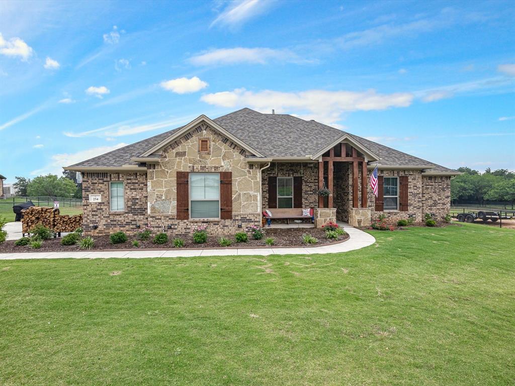 254 Odell Road Springtown, TX 76082 - Photo 1 of 1 a front view of a house with swimming pool having outdoor seating