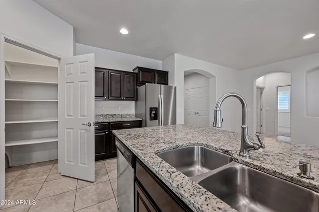 a kitchen with a sink cabinets and stainless steel appliances