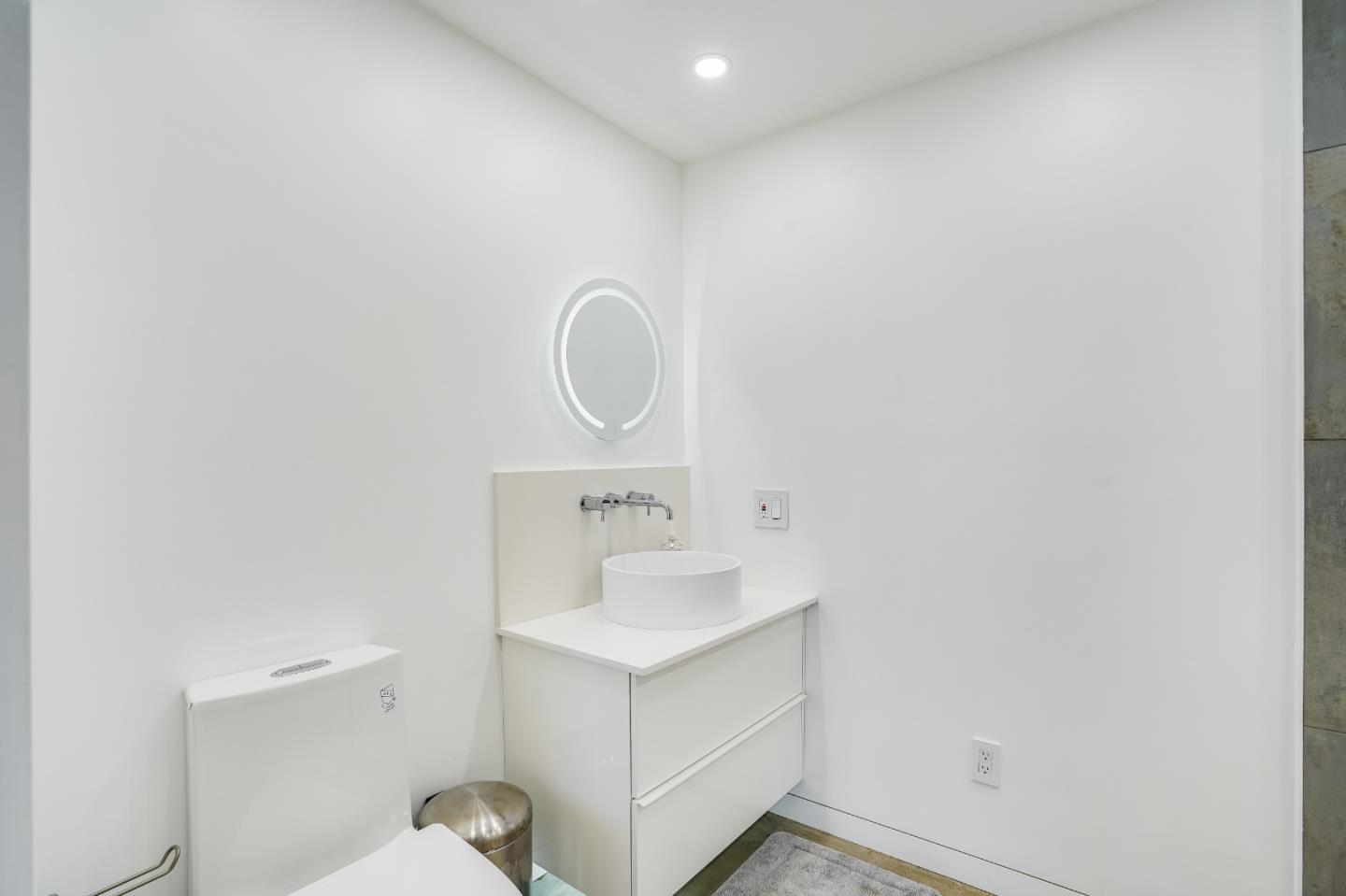 18518 Favre Ridge Road Los Gatos, CA 95033 - Photo 31 of 46 a bathroom with a sink mirror vanity and toilet