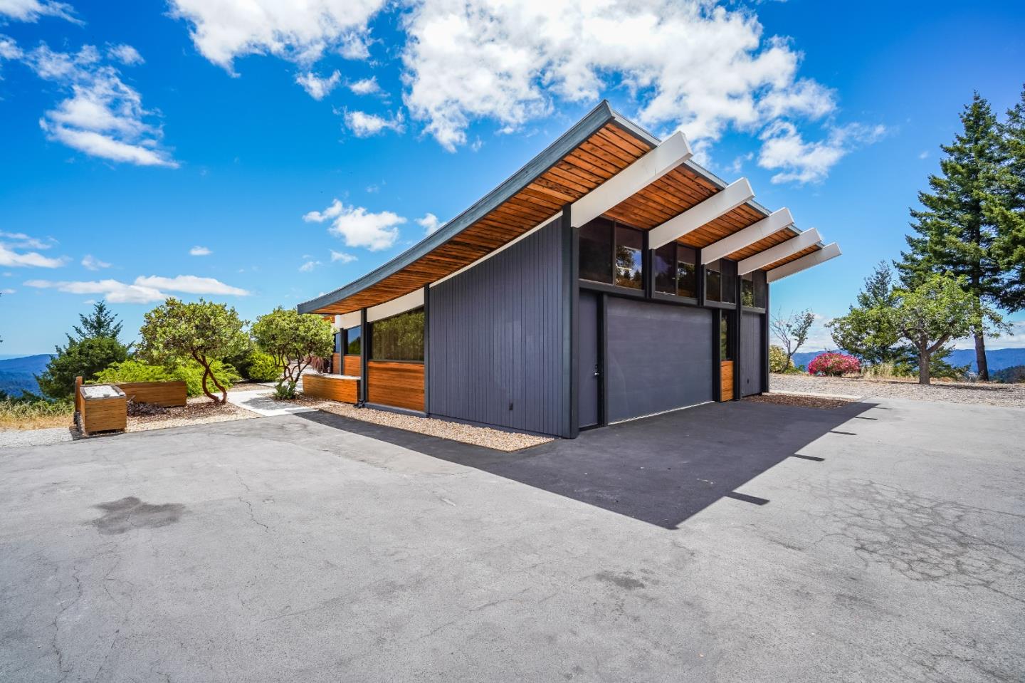 18518 Favre Ridge Road Los Gatos, CA 95033 - Photo 41 of 46 a view of a house with a yard and potted plants