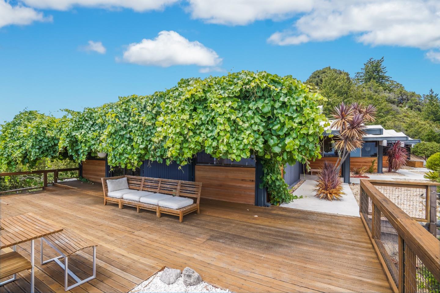 18518 Favre Ridge Road Los Gatos, CA 95033 - Photo 5 of 46 a backyard of a house with table and chairs plants