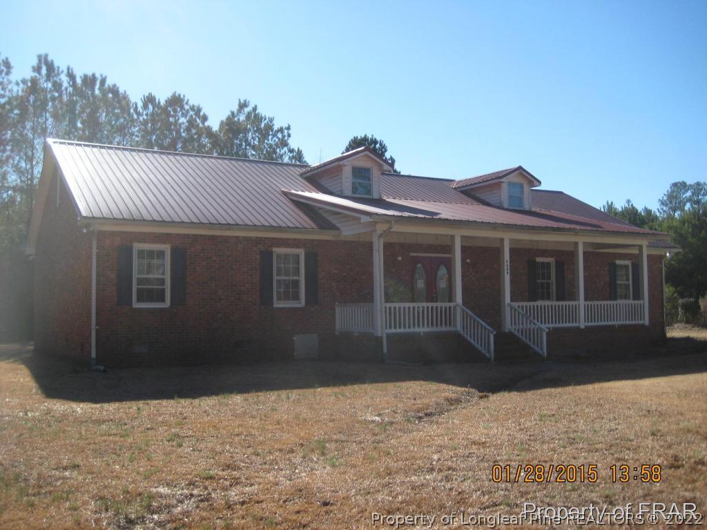 6904 Clinton Road Stedman, NC 28391 - Photo 1 of 6 a front view of a house with a yard and garage