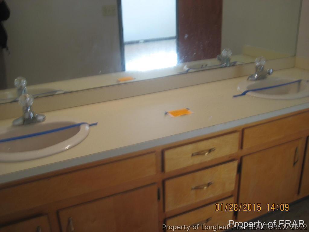 6904 Clinton Road Stedman, NC 28391 - Photo 4 of 6 a bathroom with a sink and a mirror