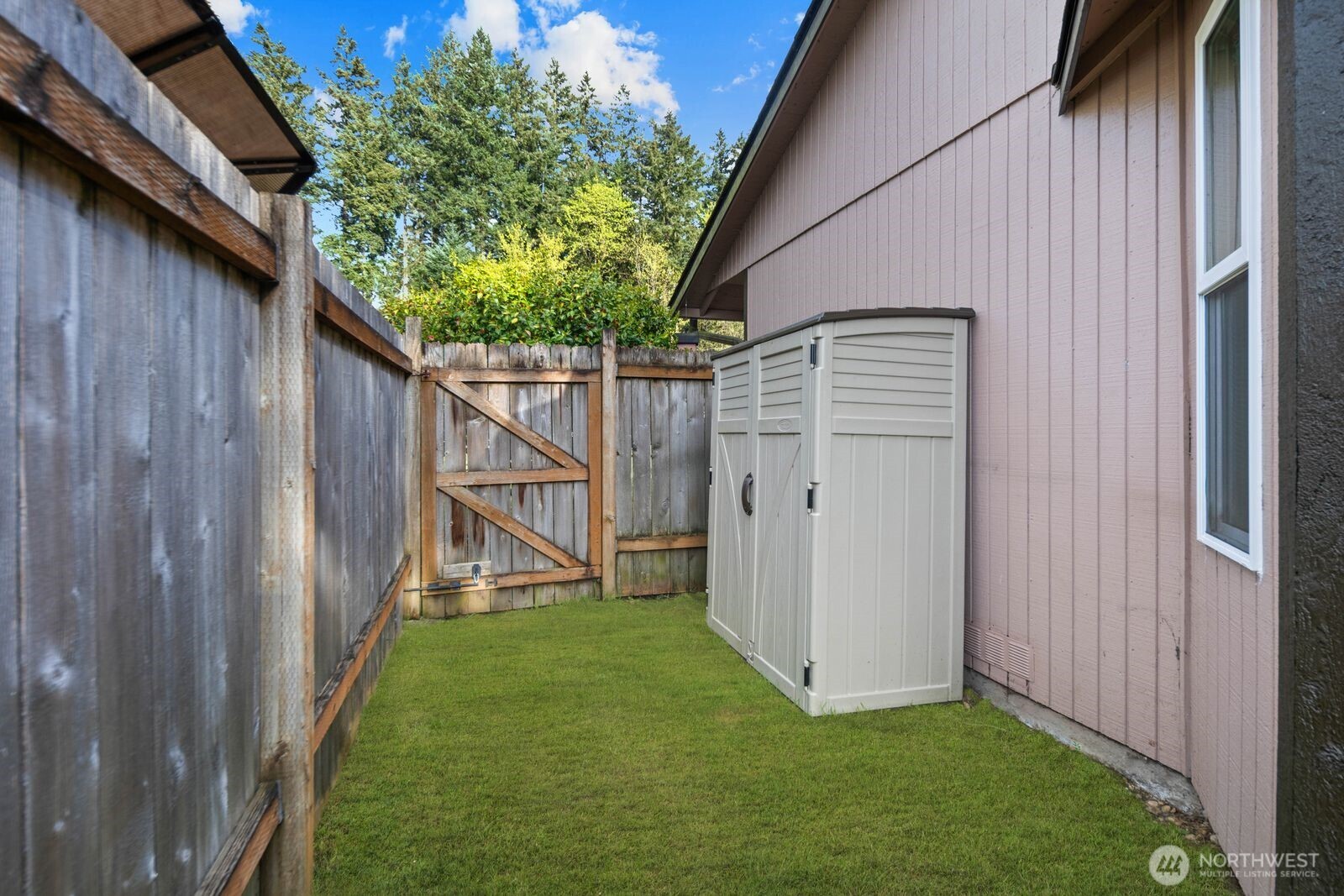 26121 193rd Place Southeast Covington, WA 98042 - Photo 19 of 21 a view of backyard with small cabin and wooden fence