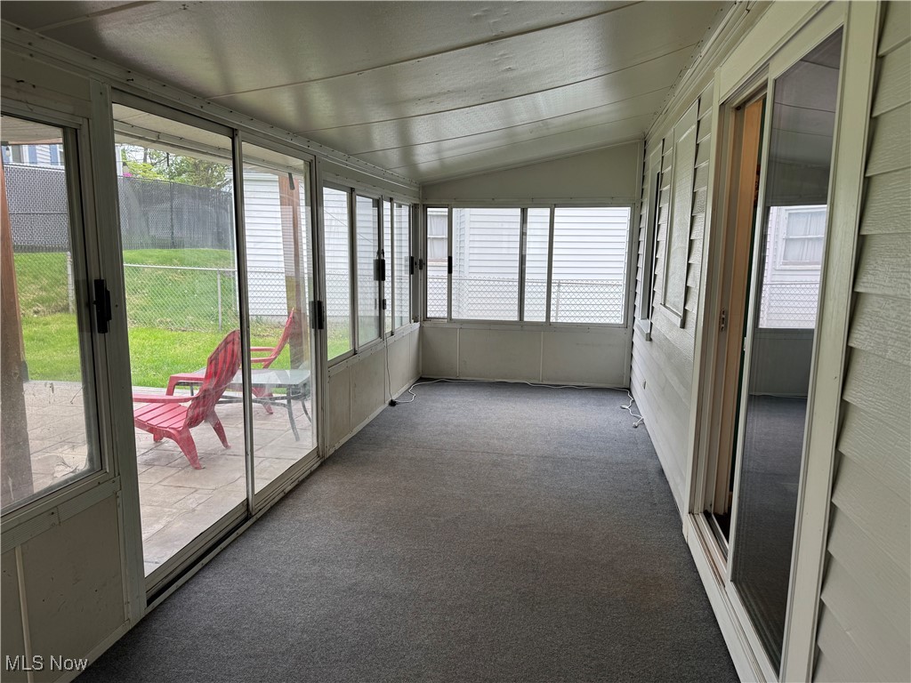 1139 Kessel Avenue Akron, OH 44310 - Photo 35 of 36 Unfurnished sunroom with vaulted ceiling and carpet
