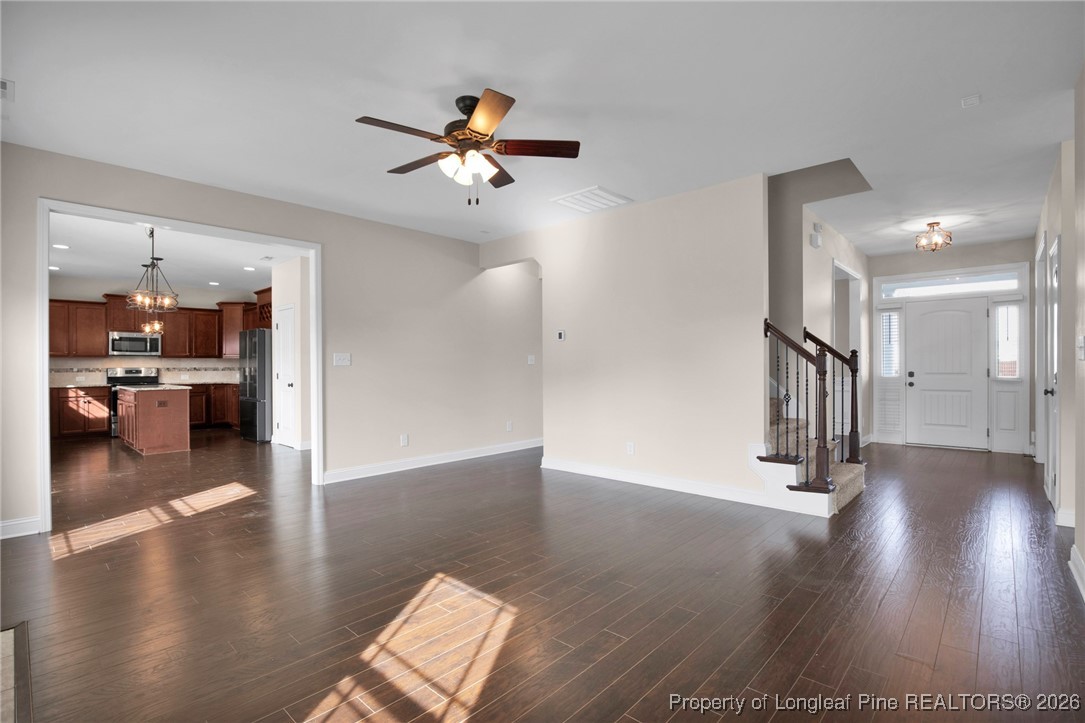 171 Tellmont Street Raeford, NC 28376 - Photo 12 of 46 a view of a hallway with wooden floor and a kitchen