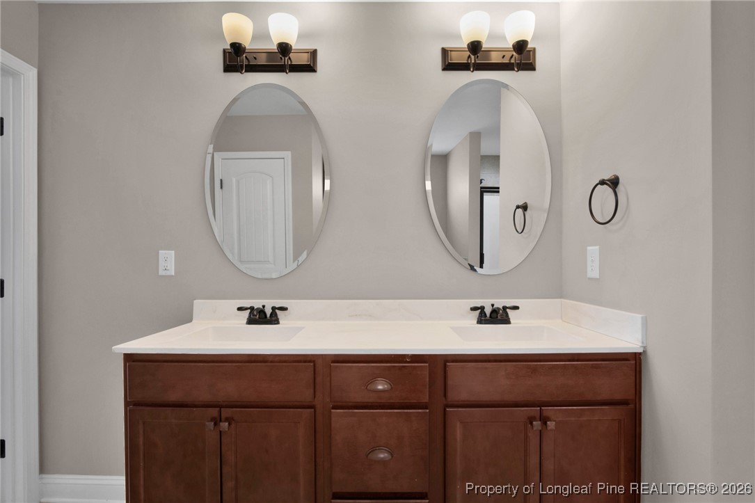 171 Tellmont Street Raeford, NC 28376 - Photo 30 of 46 a bathroom with double vanity sinks and a mirror