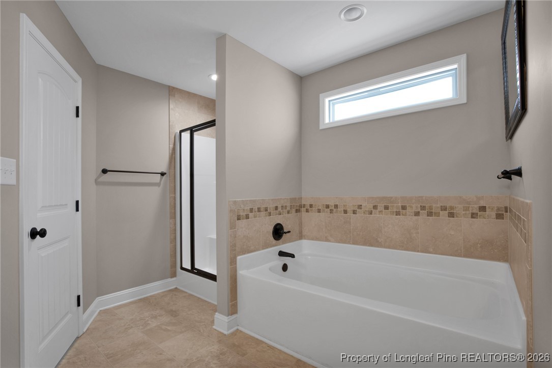 171 Tellmont Street Raeford, NC 28376 - Photo 31 of 46 a bathroom with a bathtub and a shower
