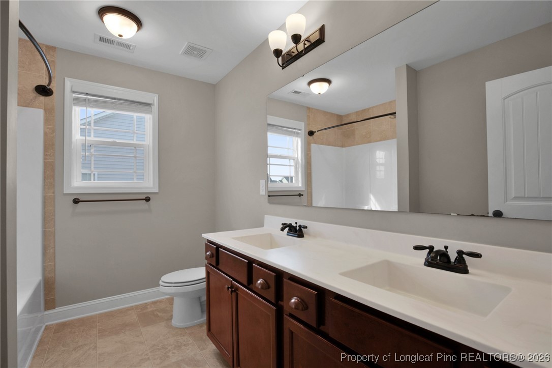 171 Tellmont Street Raeford, NC 28376 - Photo 39 of 46 a bathroom with a sink double vanity granite and a toilet
