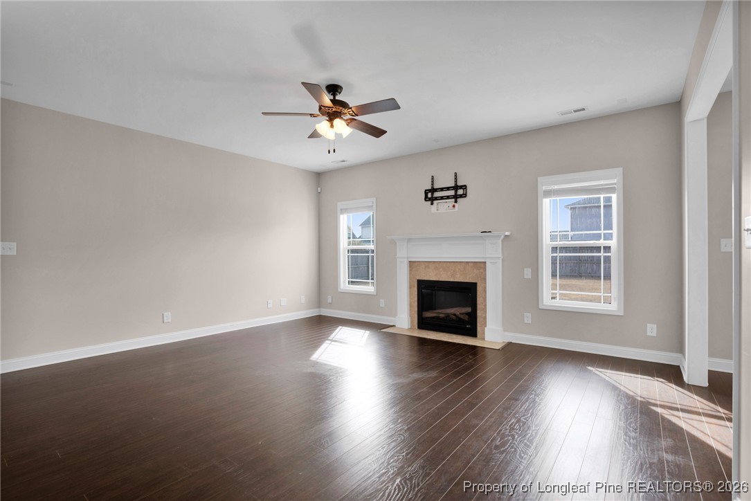 171 Tellmont Street Raeford, NC 28376 - Photo 10 of 46 a view of an empty room with wooden floor fireplace and a window