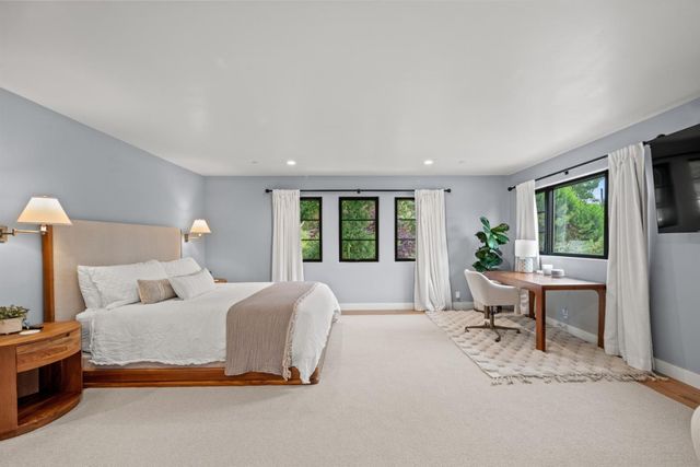 a bedroom with a large bed and a window