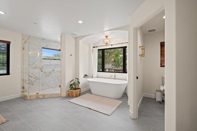 a spacious bathroom with a bathtub and a sink
