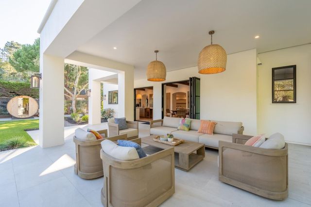a living room with furniture a window and a chandelier