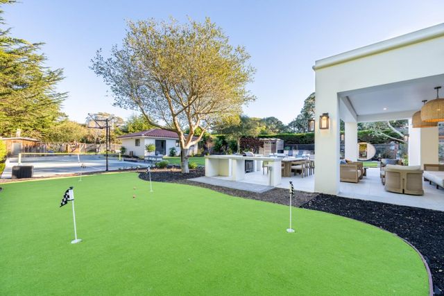 a swimming pool view with a sitting space