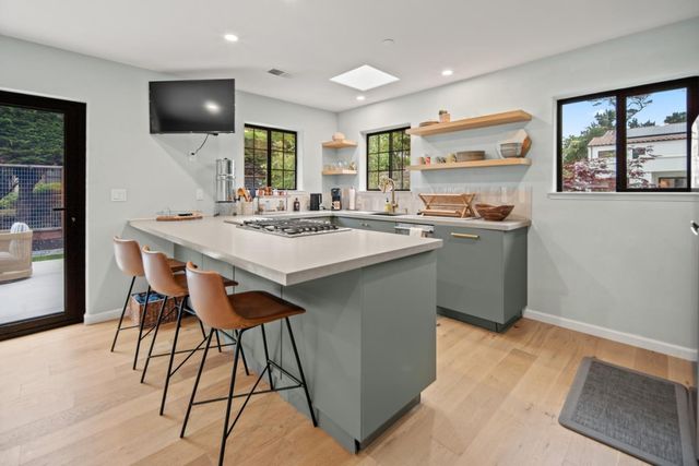 a kitchen with stainless steel appliances granite countertop a sink a stove and a refrigerator