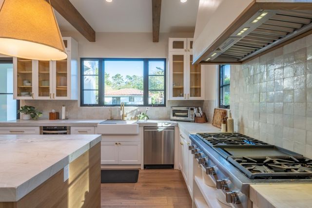 a kitchen with a stove a sink a refrigerator and window