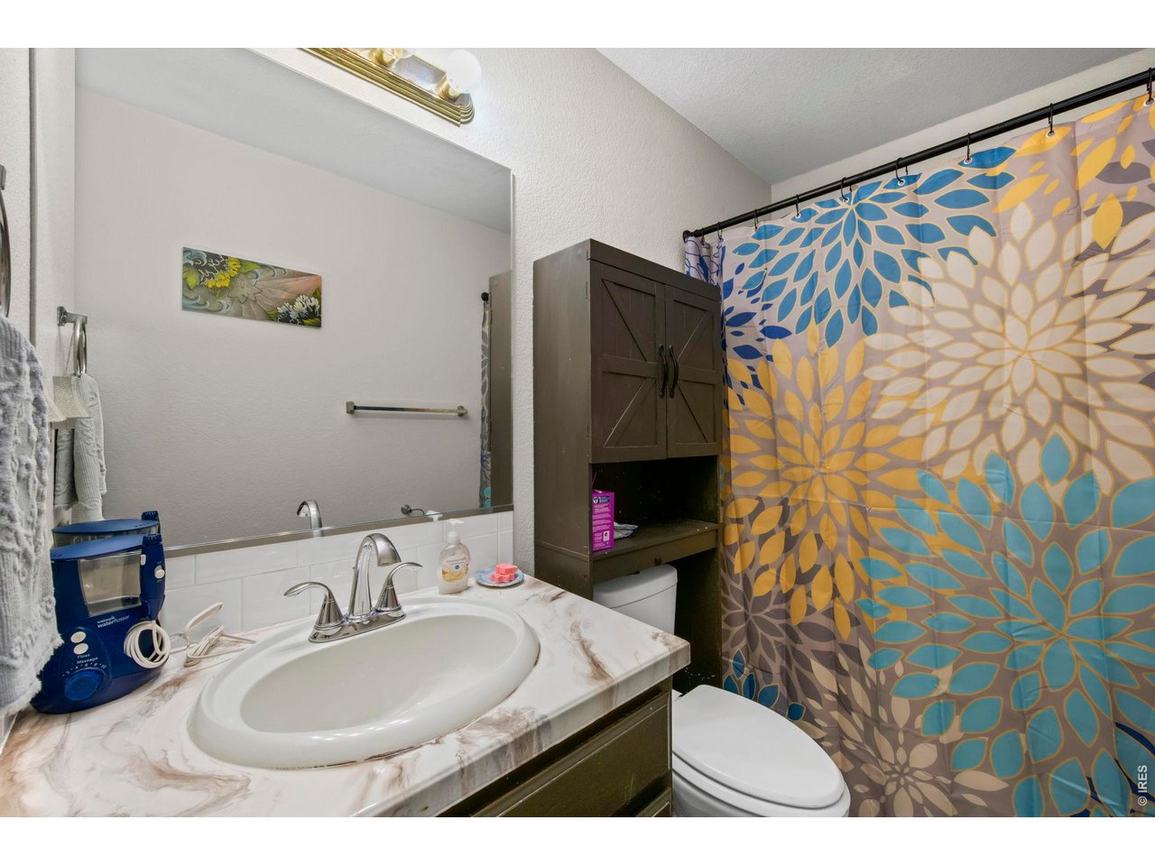 5225 West 11th Street Road Greeley, CO 80634 - Photo 11 of 17 a bathroom with a sink toilet and a mirror